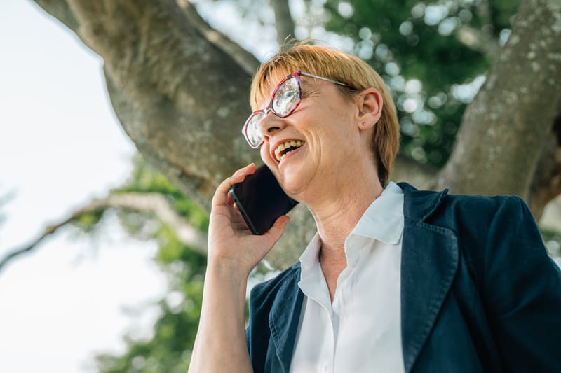 Senior lady talking on mobile outdoors, senior business woman relaxing from work, office rest Senior lady talking on mobile outdoors, senior business woman relaxing from work, office rest